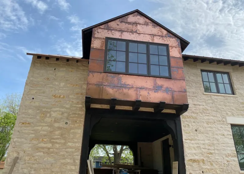 Copper metal panel facade on a stone building for Roof Repair in Danville